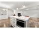 Open floor plan with modern kitchen island featuring an oven and white countertops at 1268 Scotch Meadows Loop, Monroe, NC 28110
