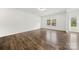 A bright, airy living room with hardwood floors and a door to the outside at 1268 Scotch Meadows Loop, Monroe, NC 28110