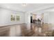 Open-concept living room showcasing wood floors and a view into the modern, bright kitchen at 1268 Scotch Meadows Loop, Monroe, NC 28110