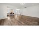 Spacious living area featuring hardwood flooring, an open floor plan, and ample natural light at 1268 Scotch Meadows Loop, Monroe, NC 28110