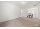 Open loft area with neutral carpeting and a stylish chair at 1268 Scotch Meadows Loop, Monroe, NC 28110