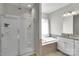Bathroom featuring glass shower, soaking tub, granite countertops, and white cabinets at 128 Stibbs Cross Rd, Mooresville, NC 28115