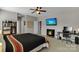 Bedroom boasts a ceiling fan, a TV mounted above an electric fireplace, and an office space at 128 Stibbs Cross Rd, Mooresville, NC 28115