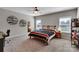 Bedroom with a large bed, ceiling fan, two windows with blinds, and carpet flooring at 128 Stibbs Cross Rd, Mooresville, NC 28115