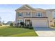 Charming two-story home featuring a well-manicured lawn, a two-car garage, and classic curb appeal at 128 Stibbs Cross Rd, Mooresville, NC 28115