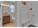 Hallway with decorative accents, bench with hooks, and access to the bathroom at 128 Stibbs Cross Rd, Mooresville, NC 28115