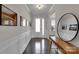 Bright hallway featuring wood floors, neutral walls with framed pictures, and a modern mirror at 128 Stibbs Cross Rd, Mooresville, NC 28115