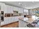 Bright kitchen featuring white cabinetry, granite countertops, and a functional center island at 128 Stibbs Cross Rd, Mooresville, NC 28115