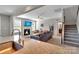 Comfortable living room featuring a fireplace, large windows, and plush sofa at 128 Stibbs Cross Rd, Mooresville, NC 28115