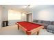 This basement features a pool table and comfortable sofa at 13620 Castleford Dr, Mint Hill, NC 28227