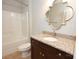Cozy bathroom featuring a granite vanity, decorative mirror, and a shower/tub combo at 13620 Castleford Dr, Mint Hill, NC 28227