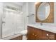 Well-lit bathroom with marble countertop, shower, and wood-style vanity at 13620 Castleford Dr, Mint Hill, NC 28227