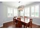 Dining room with wood table and decorative chandelier and lots of light from shuttered windows at 13620 Castleford Dr, Mint Hill, NC 28227