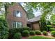 Beautiful brick home exterior featuring manicured landscaping and charming architectural details at 13620 Castleford Dr, Mint Hill, NC 28227