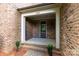 Covered front porch with brick columns and a view of the front yard at 13620 Castleford Dr, Mint Hill, NC 28227