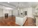 Bright, open kitchen with an island and stainless steel appliances next to the open living area at 13620 Castleford Dr, Mint Hill, NC 28227