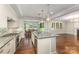 Bright kitchen featuring an island, stainless steel appliances, and a view into the dining room at 13620 Castleford Dr, Mint Hill, NC 28227