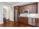 Kitchenette with stainless steel appliances, granite counters, and ample cabinet space at 13620 Castleford Dr, Mint Hill, NC 28227