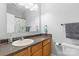 Well-lit bathroom featuring a granite countertop, large mirror, and shower with decorative shower curtain at 1386 21St Ne Ave, Hickory, NC 28601