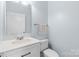Bright bathroom with a large mirror, white vanity, modern fixtures, and a sleek, minimalist design at 1386 21St Ne Ave, Hickory, NC 28601