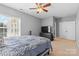 Bedroom with a ceiling fan, double closet, TV, and dresser, creating a relaxing personal space at 1386 21St Ne Ave, Hickory, NC 28601