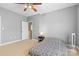 Well-lit bedroom featuring a ceiling fan, bedside table and lamp, neutral carpet, and freshly painted walls at 1386 21St Ne Ave, Hickory, NC 28601