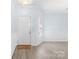 Bright foyer with modern gray vinyl flooring, white wainscoting, and a welcome mat at 1386 21St Ne Ave, Hickory, NC 28601