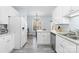 Open kitchen space with white cabinets, stainless steel appliances, and easy access to the dining area at 1386 21St Ne Ave, Hickory, NC 28601