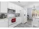Bright kitchen features white cabinetry, modern appliances, gray stone flooring, and abundant natural light at 1386 21St Ne Ave, Hickory, NC 28601