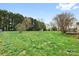 Manicured backyard with lush lawn and tree line; outdoor living at its finest at 139 Meadow Oaks Dr, Statesville, NC 28625