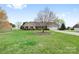 Landscaped yard with beautiful flowering trees surrounding this charming brick ranch home at 139 Meadow Oaks Dr, Statesville, NC 28625