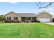 Charming brick ranch home with a well-maintained lawn and an attached two car garage at 139 Meadow Oaks Dr, Statesville, NC 28625