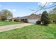 Brick ranch home with a manicured lawn and mature landscaping at 139 Meadow Oaks Dr, Statesville, NC 28625