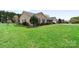 Beautifully landscaped yard and charming brick home with manicured lawn at 139 Meadow Oaks Dr, Statesville, NC 28625