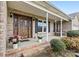 Inviting front porch with rocking chairs and a decorative wooden front door at 139 Meadow Oaks Dr, Statesville, NC 28625