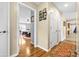 Hallway showing access to the bedroom with hardwood floors and neutral colored walls at 139 Meadow Oaks Dr, Statesville, NC 28625