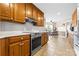 Open kitchen with stainless steel oven and hood, connecting to a cozy dining area at 139 Meadow Oaks Dr, Statesville, NC 28625