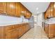 Well-lit kitchen featuring wood cabinets, stainless steel appliances and tile floors at 139 Meadow Oaks Dr, Statesville, NC 28625