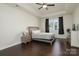 A spacious bedroom featuring tray ceilings, dark hardwood floors, and natural light at 1495 Imperial Ct, York, SC 29745