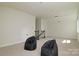 Spacious bonus room with two beanbag chairs, neutral walls, and access to the staircase at 1495 Imperial Ct, York, SC 29745