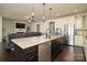 Open-concept kitchen with stainless appliances, island, and hardwood floors flowing to living area at 1495 Imperial Ct, York, SC 29745