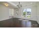 Elegant living room featuring dark hardwood floors, a modern chandelier, and large arched windows at 1495 Imperial Ct, York, SC 29745
