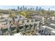 Aerial view of modern townhouses with rooftop decks and the city skyline in the distance at 1617 Cannon View Ln, Charlotte, NC 28208