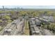 An aerial of townhouses with rooftop decks and green spaces, with city views in the distance at 1617 Cannon View Ln, Charlotte, NC 28208