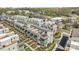 Aerial view of townhouses featuring rooftop decks, green spaces, and tree-lined streets at 1617 Cannon View Ln, Charlotte, NC 28208