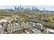 A diverse neighborhood showcases modern townhomes against a backdrop of a bustling skyline and verdant trees, creating urban appeal at 1617 Cannon View Ln, Charlotte, NC 28208
