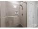 A modern shower offers sleek gray tile, a rainfall shower head, and a built-in shelf for toiletries at 1617 Cannon View Ln, Charlotte, NC 28208