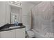 Bright bathroom offers vanity, and a shower-tub combo, providing a functional and stylish space at 1617 Cannon View Ln, Charlotte, NC 28208