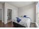 This well-lit bedroom offers a view to the ensuite bathroom, hardwood floors, and natural light at 1617 Cannon View Ln, Charlotte, NC 28208