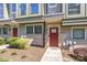 Close-up exterior shot of townhomes with red doors, clean landscaping, and visible house numbers at 1617 Cannon View Ln, Charlotte, NC 28208